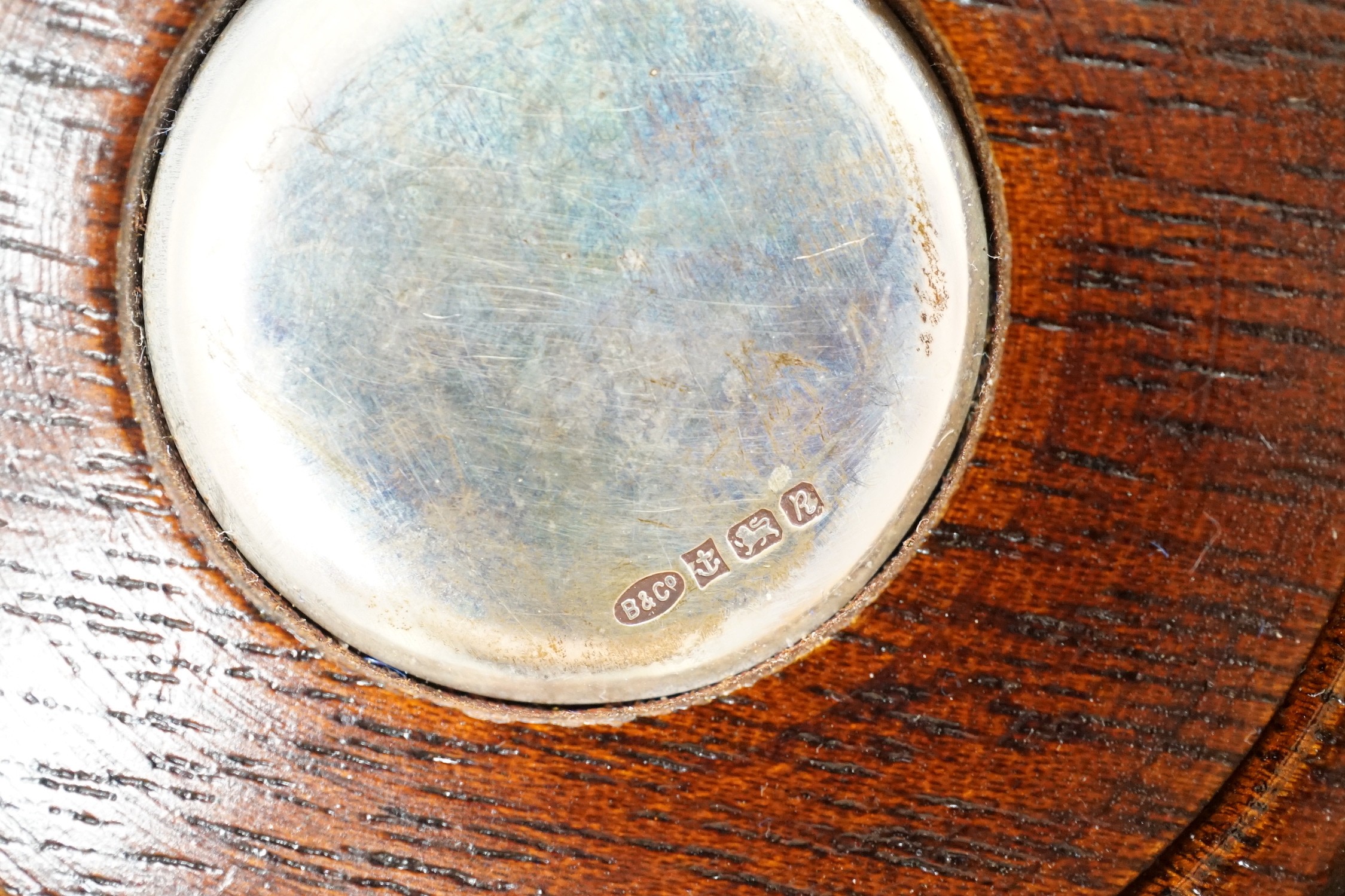 A modern silver mounted bottle coaster and two continental white metal small dishes.